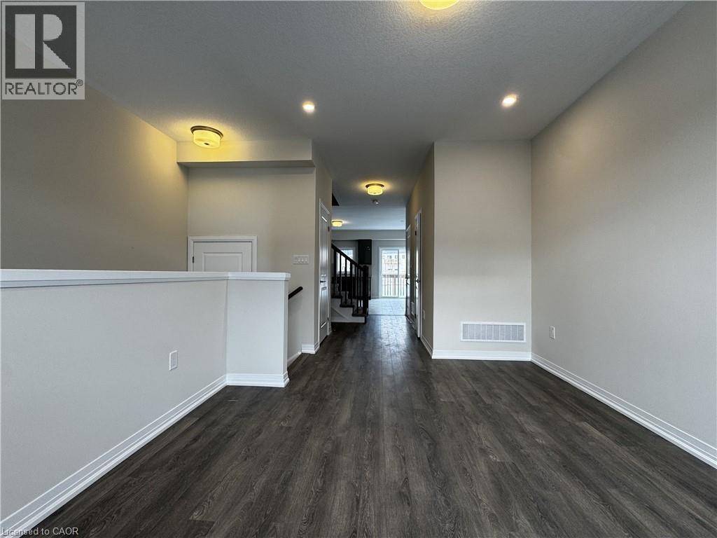 Empty room with dark wood-style floors, stairs, recessed lighting, and a textured ceiling - 660 Colborne Street W Unit# 57, Brantford, ON - Indoor Photo Showing Other Room