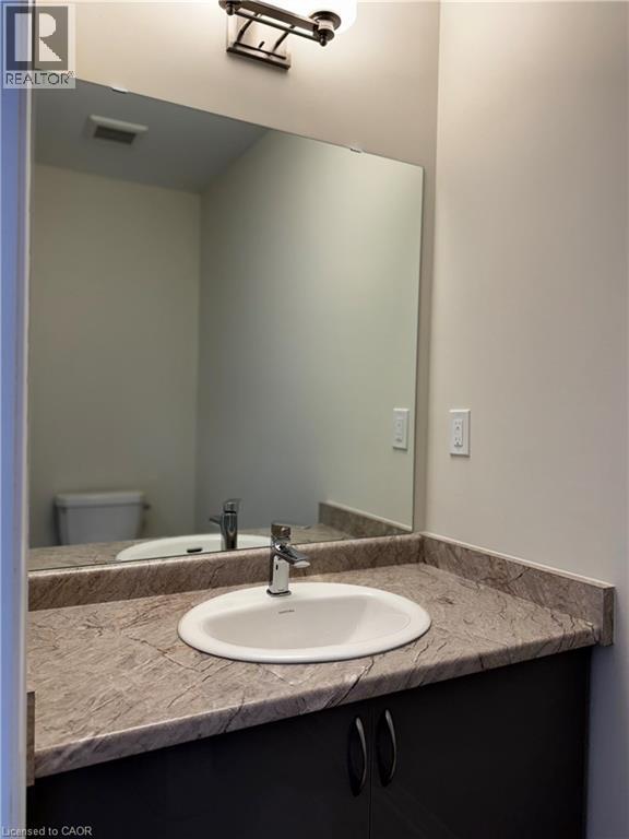 Half bathroom with vanity and toilet - 660 Colborne Street W Unit# 57, Brantford, ON - Indoor Photo Showing Bathroom