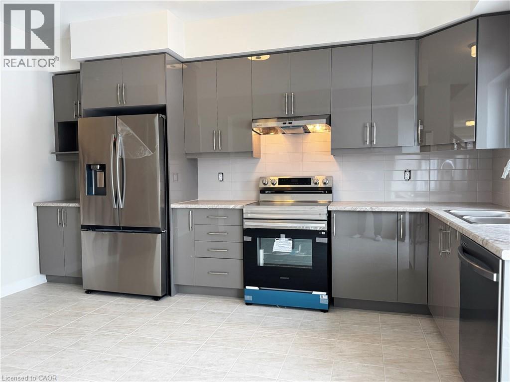 Kitchen with gray cabinetry, stainless steel appliances, and decorative backsplash - 660 Colborne Street W Unit# 57, Brantford, ON - Indoor Photo Showing Kitchen With Double Sink