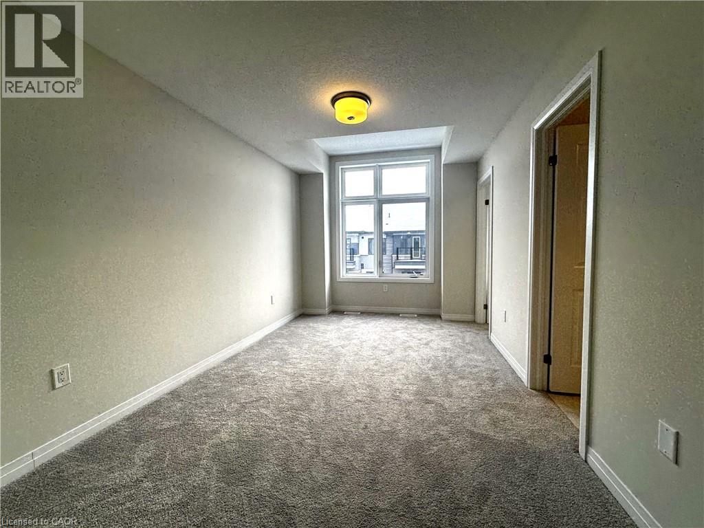 Spare room featuring a textured ceiling, carpet floors, and a textured wall - 660 Colborne Street W Unit# 57, Brantford, ON - Indoor Photo Showing Other Room