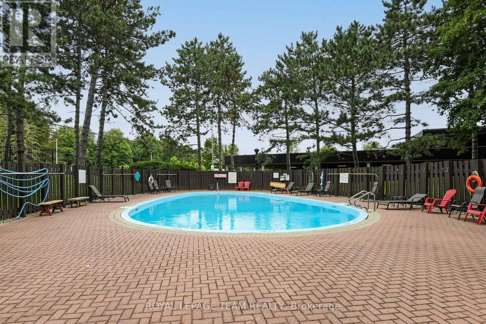 113 - 2951 Riverside Drive, Ottawa, ON - Outdoor With In Ground Pool With Backyard