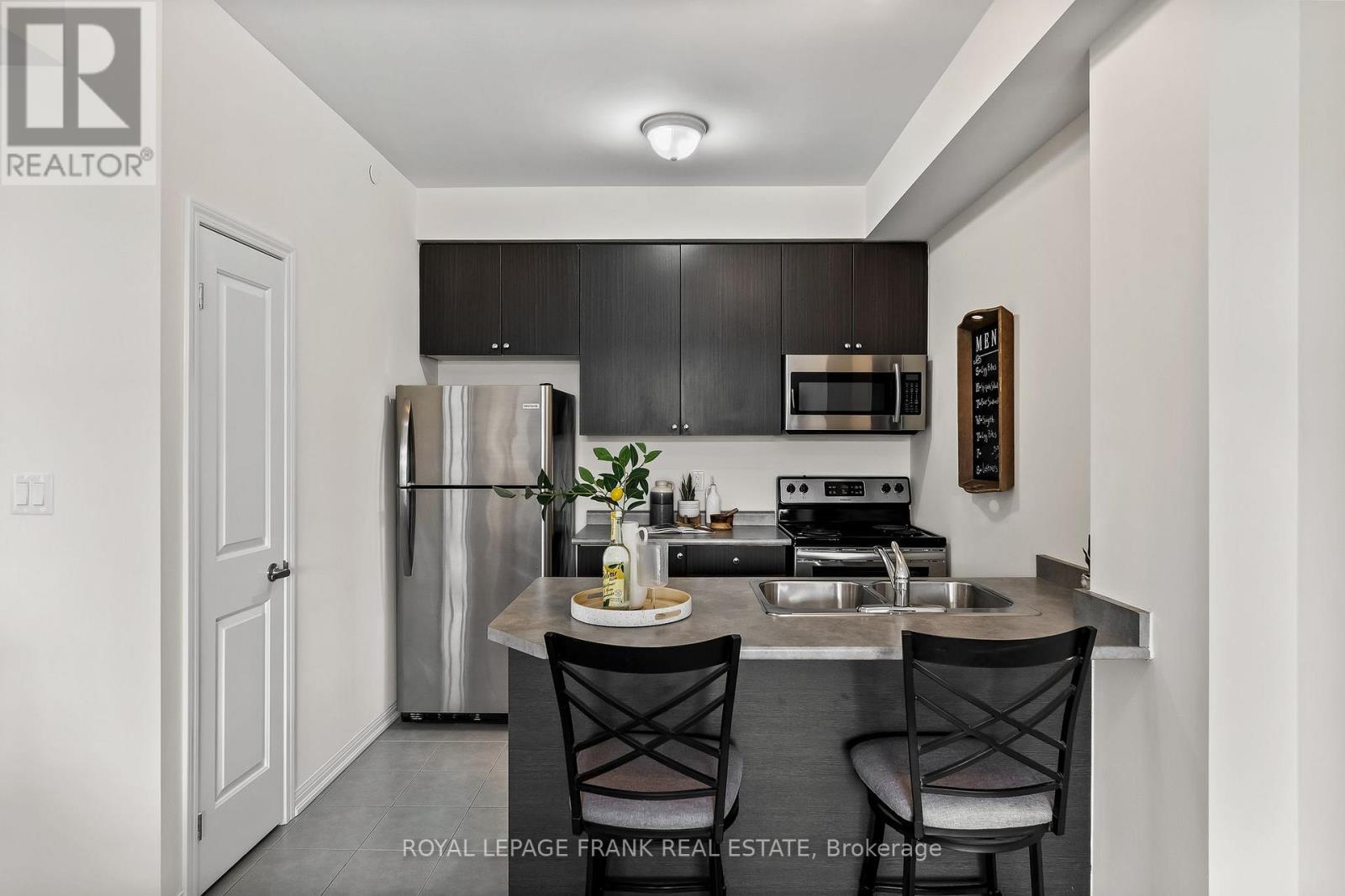 405 - 80 Aspen Springs Drive, Clarington (Bowmanville), ON - Indoor Photo Showing Kitchen With Double Sink