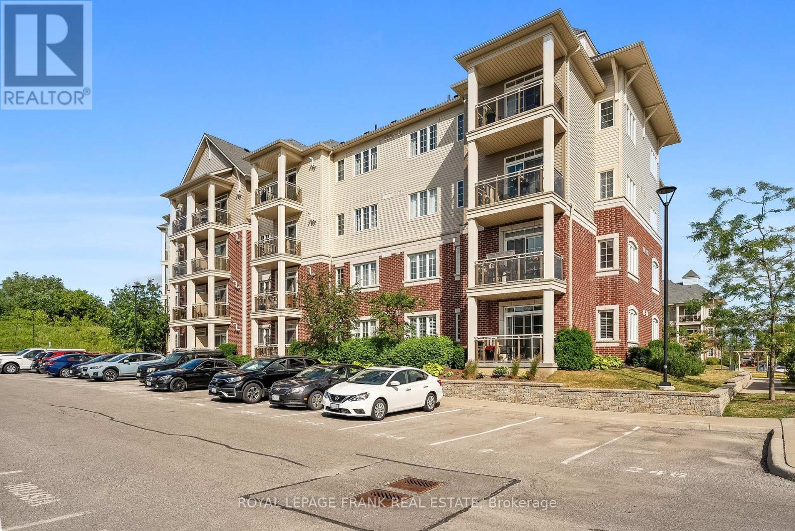 405 - 80 Aspen Springs Drive, Clarington (Bowmanville), ON - Outdoor With Balcony With Facade