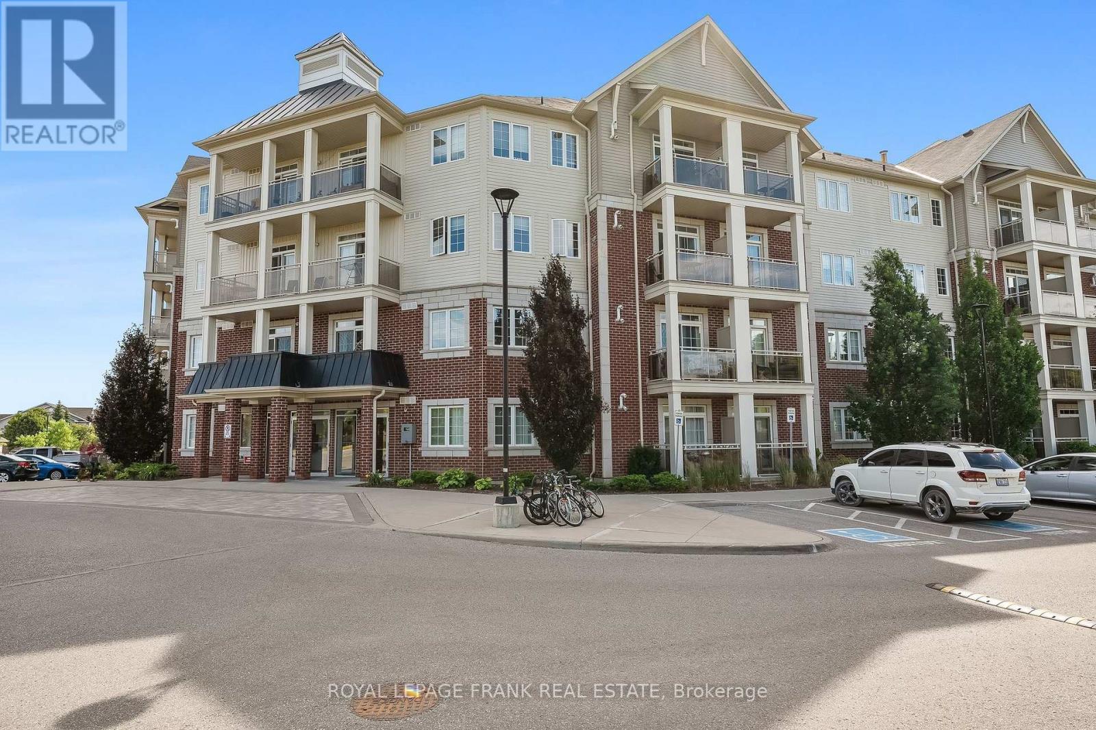 405 - 80 Aspen Springs Drive, Clarington (Bowmanville), ON - Outdoor With Balcony With Facade