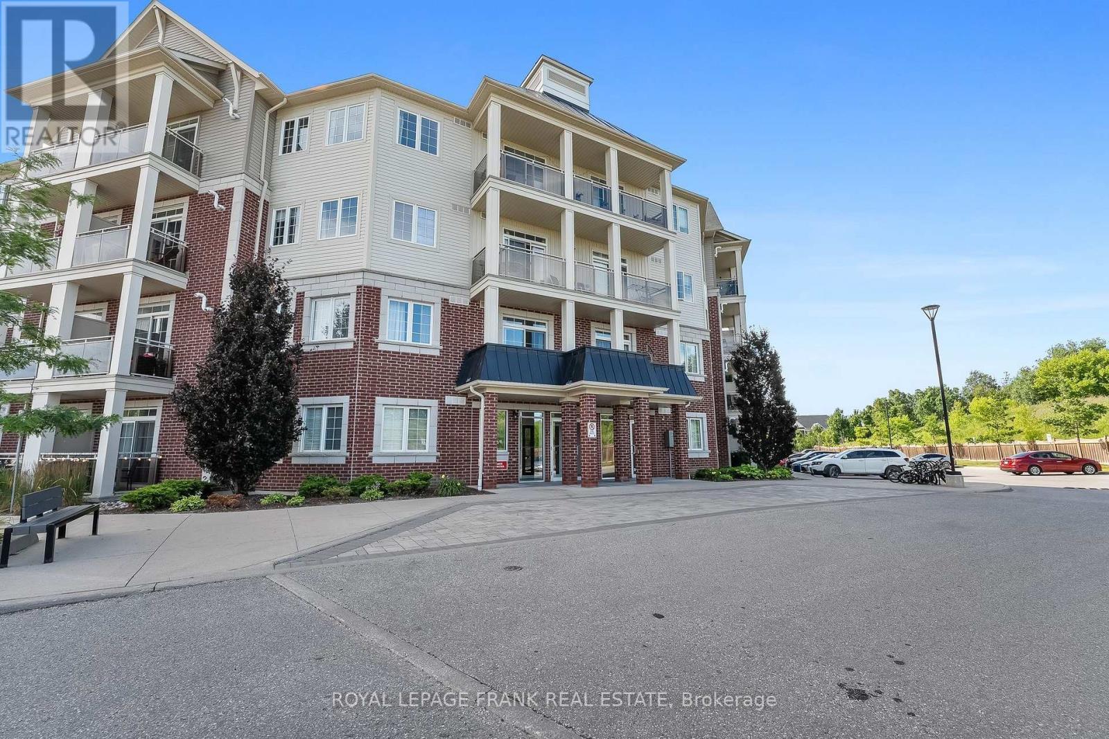 405 - 80 Aspen Springs Drive, Clarington (Bowmanville), ON - Outdoor With Balcony With Facade