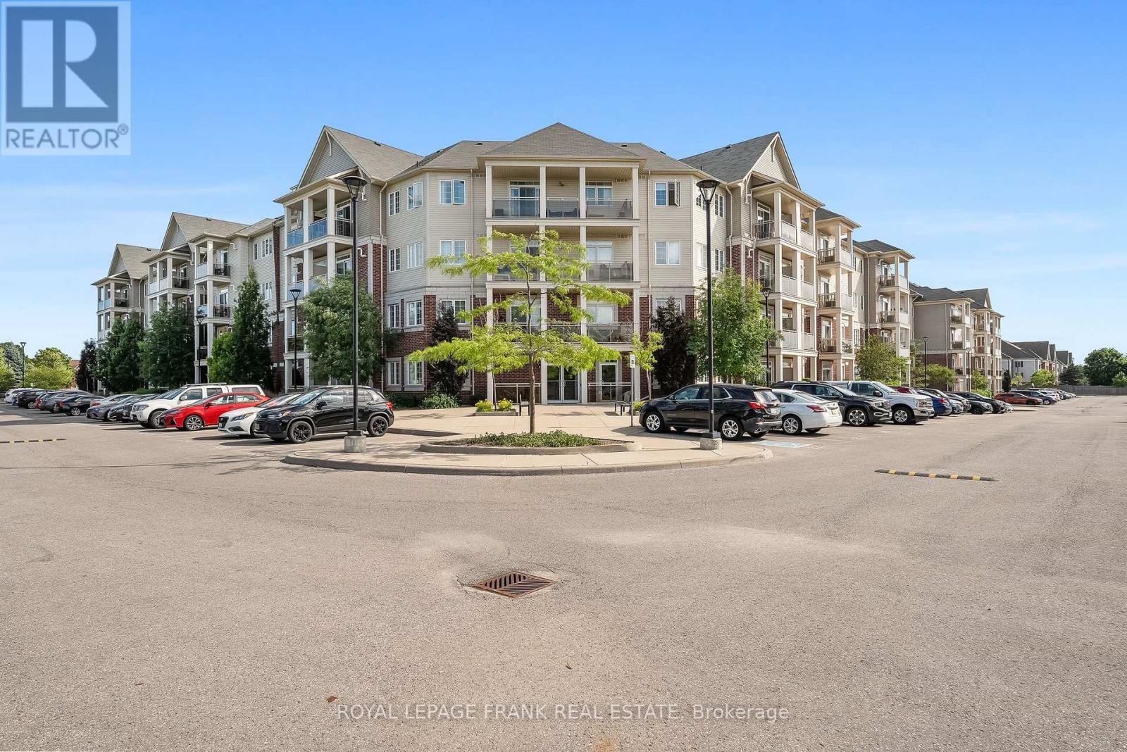 405 - 80 Aspen Springs Drive, Clarington (Bowmanville), ON - Outdoor With Balcony With Facade
