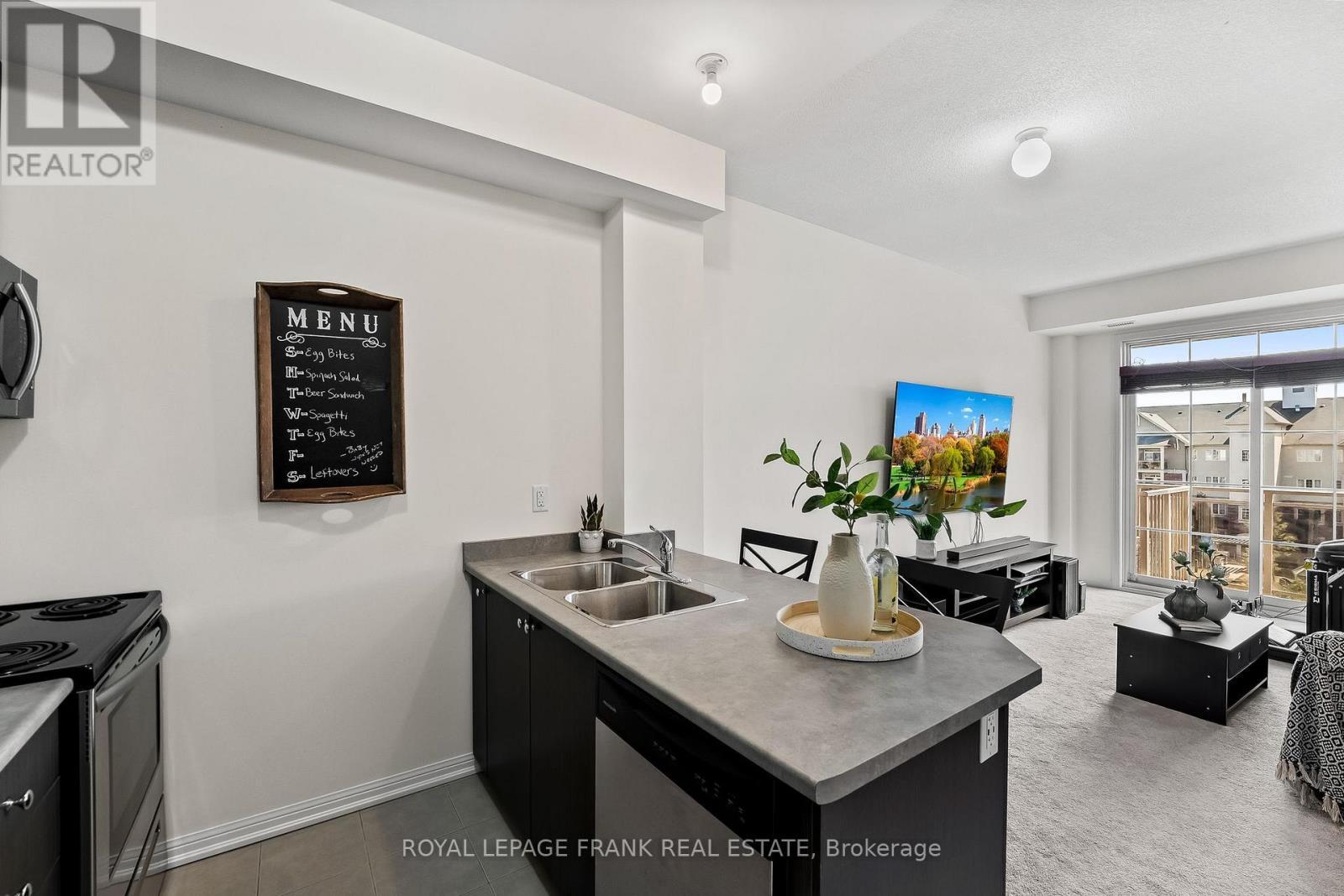 405 - 80 Aspen Springs Drive, Clarington (Bowmanville), ON - Indoor Photo Showing Kitchen With Double Sink