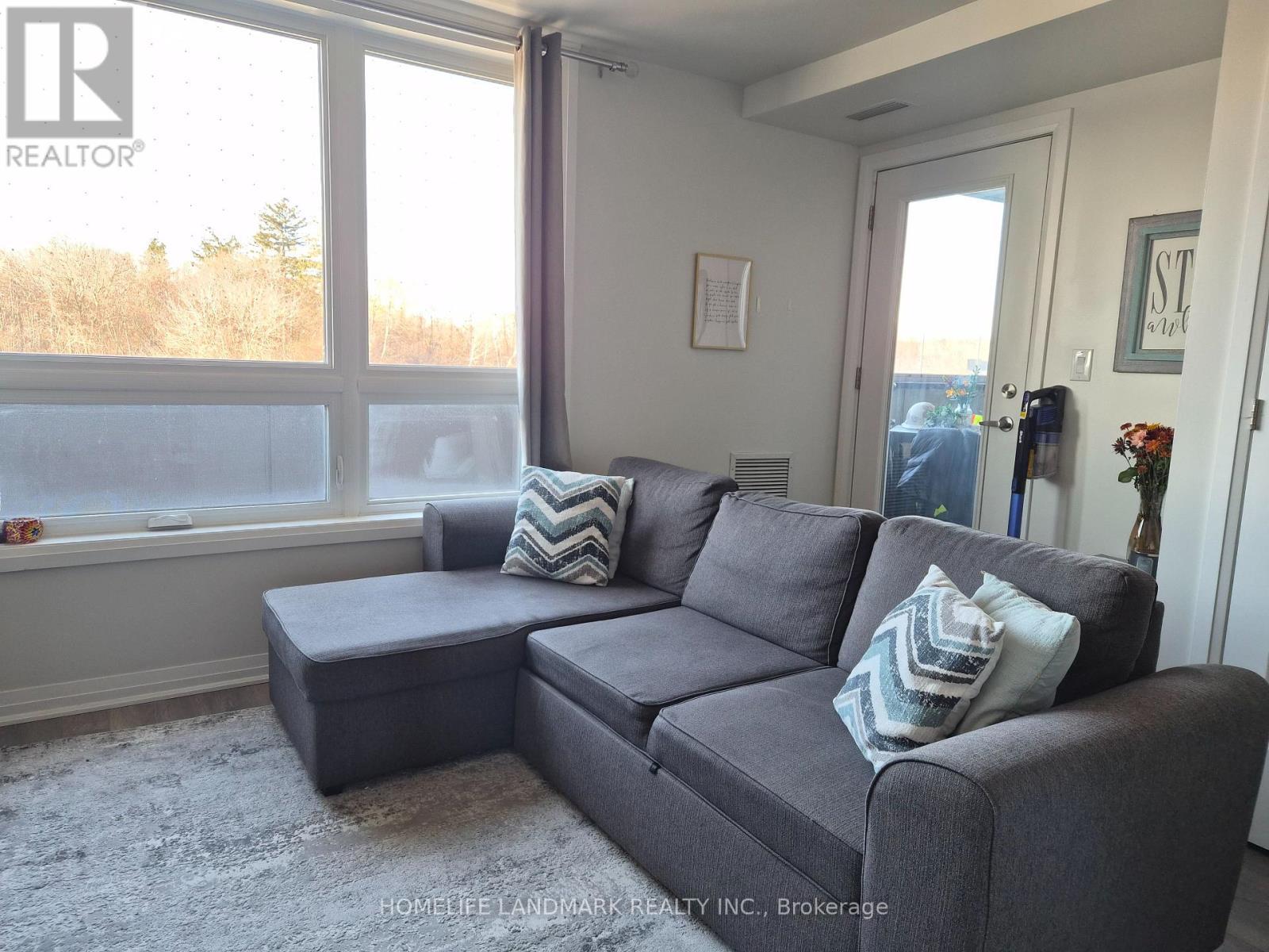 213 - 2 Adam Sellers Street, Markham, ON - Indoor Photo Showing Living Room