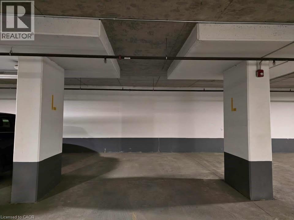 View of parking deck - 1430 Highland Road W Unit# 7C, Kitchener, ON - Indoor Photo Showing Garage