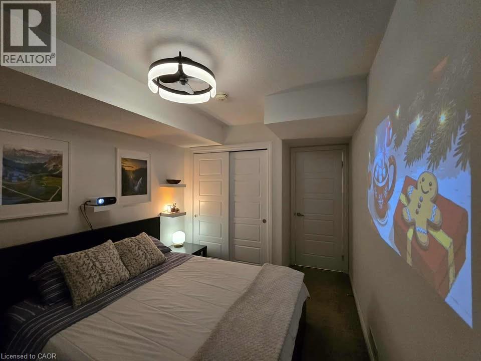 Bedroom featuring a closet, a textured ceiling, and dark carpet - 1430 Highland Road W Unit# 7C, Kitchener, ON - Indoor Photo Showing Bedroom