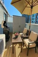 Wooden deck featuring a patio area -