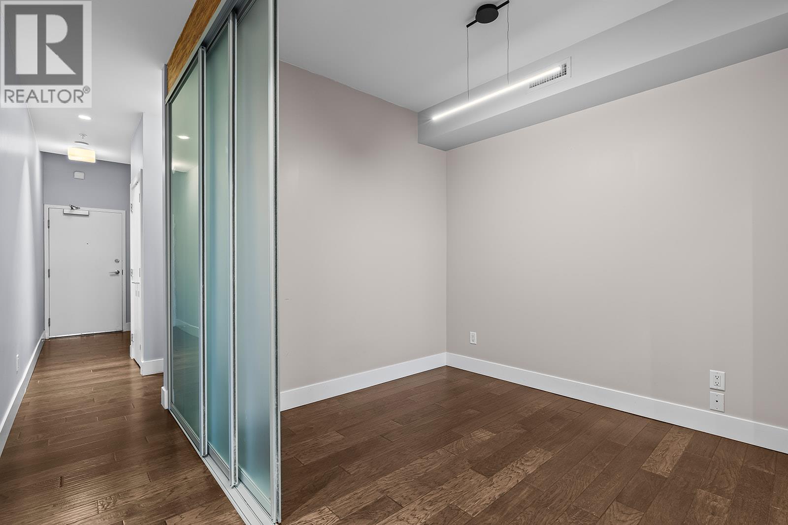 den with sliding doors for privacy - 1289 Ellis Street Unit# 411, Kelowna, BC - Indoor Photo Showing Other Room