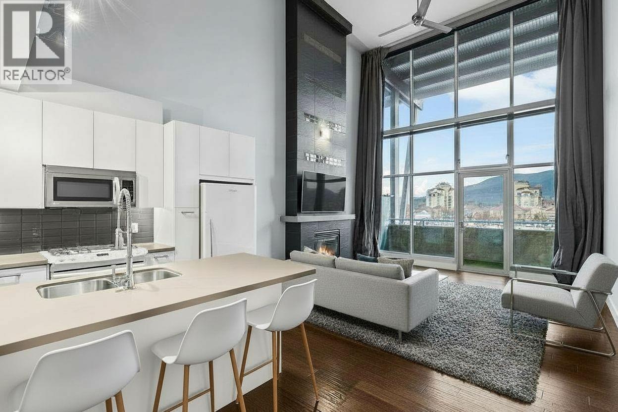 virtually staged - 1289 Ellis Street Unit# 411, Kelowna, BC - Indoor Photo Showing Kitchen With Fireplace With Upgraded Kitchen