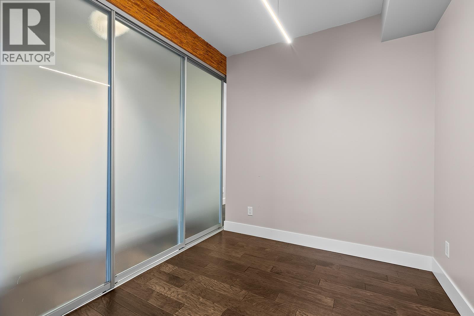 den with sliding doors for privacy - 1289 Ellis Street Unit# 411, Kelowna, BC - Indoor Photo Showing Other Room