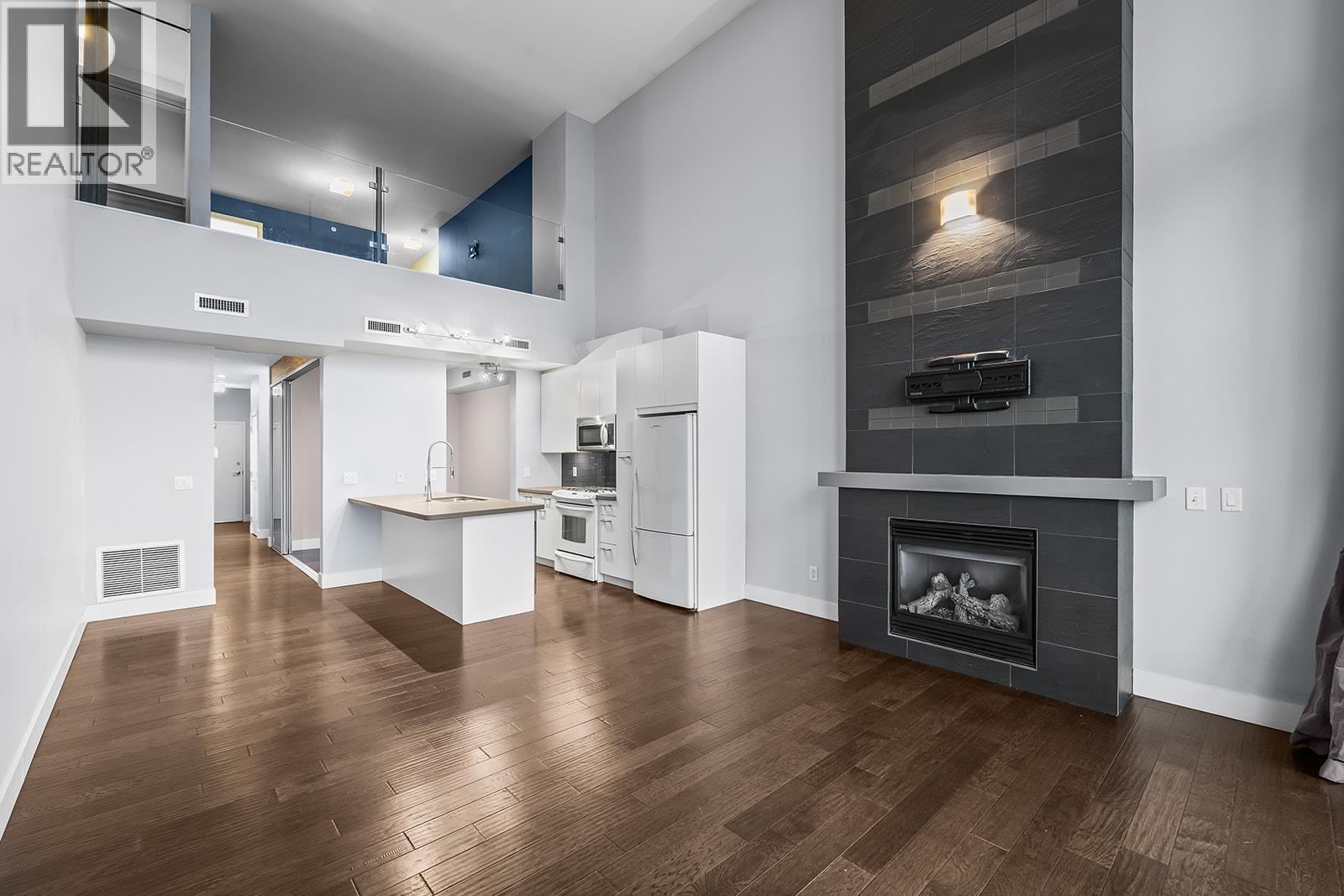 1289 Ellis Street Unit# 411, Kelowna, BC - Indoor Photo Showing Living Room With Fireplace