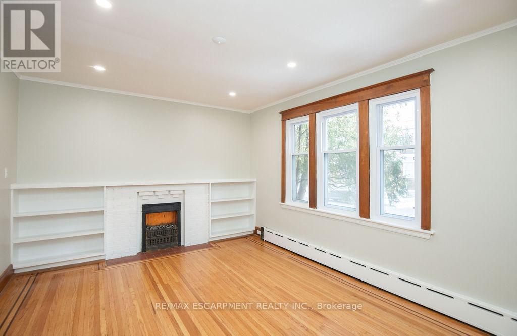Bedroom 1 - 1 - 22 Prospect Street S, Hamilton, ON - Indoor Photo Showing Other Room With Fireplace