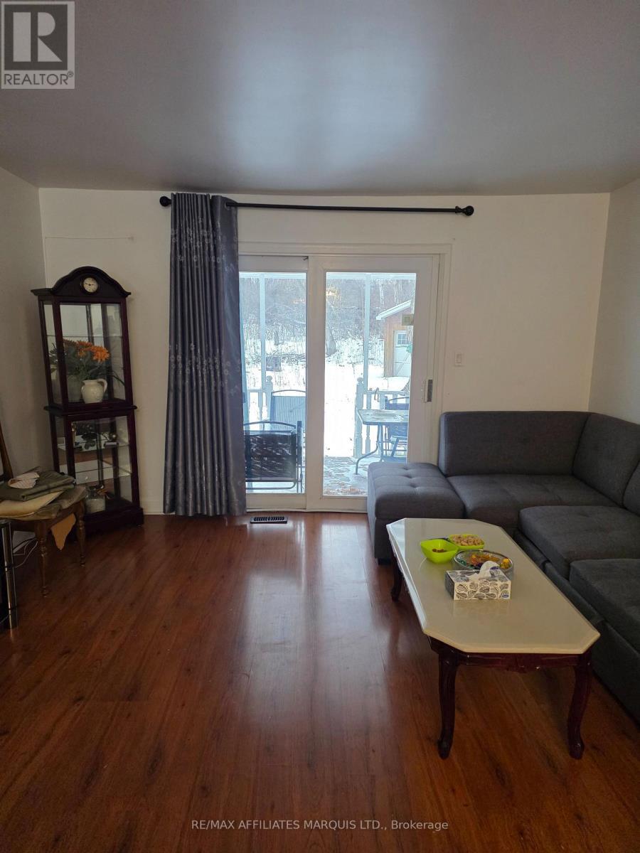 Living room w/ patio doors to rear covered deck - 3233 Richmond Drive, Cornwall, ON - Indoor Photo Showing Living Room