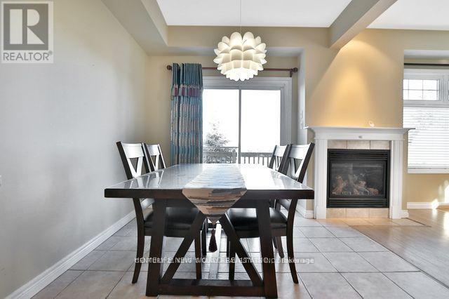 21 - 232 Stonehenge Drive, Hamilton, ON - Indoor Photo Showing Dining Room With Fireplace