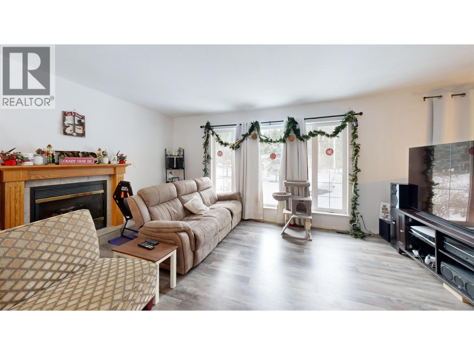 4983 Smith Road, 108 Mile Ranch, BC - Indoor Photo Showing Living Room With Fireplace
