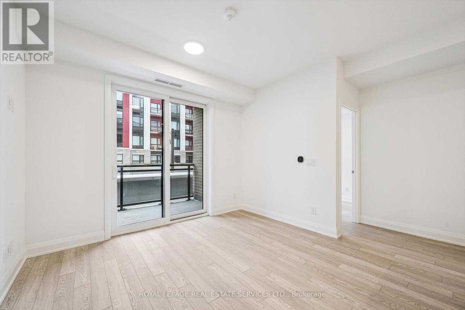 Living/Dining Area with Walkout to Private Balcony - 223 - 3250 Carding Mill Trail, Oakville, ON - Indoor Photo Showing Other Room