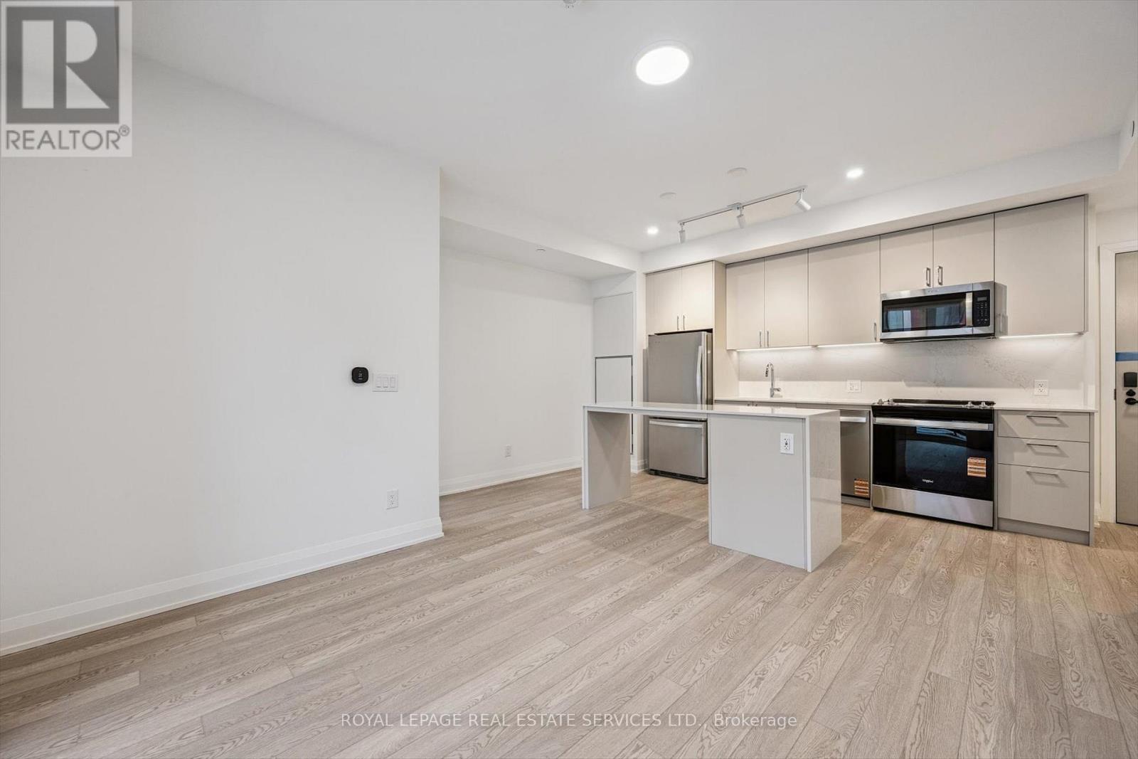 Enjoy Wide-Plank Laminate Flooring Throughout - 223 - 3250 Carding Mill Trail, Oakville, ON - Indoor Photo Showing Kitchen With Stainless Steel Kitchen