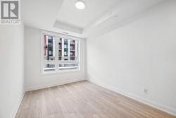 Primary Bedroom with Wide Plank Laminate Flooring -