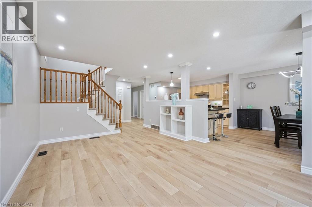 Living room with stairway, recessed lighting, and light wood-style floors - 723 Black Cherry Street, Waterloo, ON - Indoor