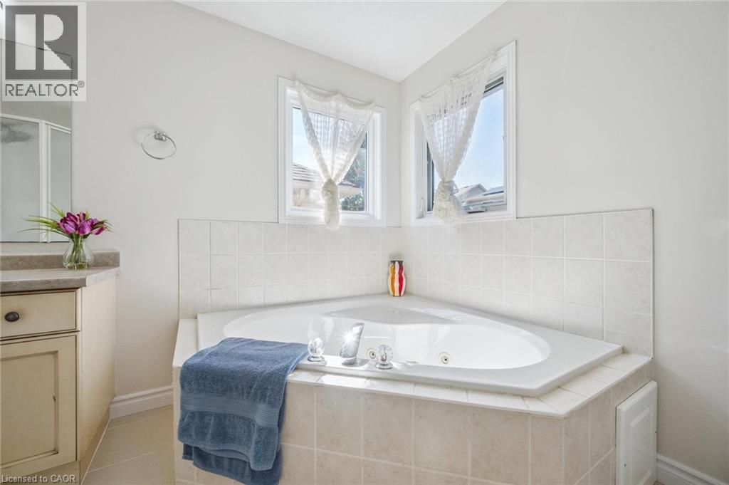 Bathroom with a shower stall, a whirlpool tub, and vanity - 723 Black Cherry Street, Waterloo, ON - Indoor Photo Showing Bathroom