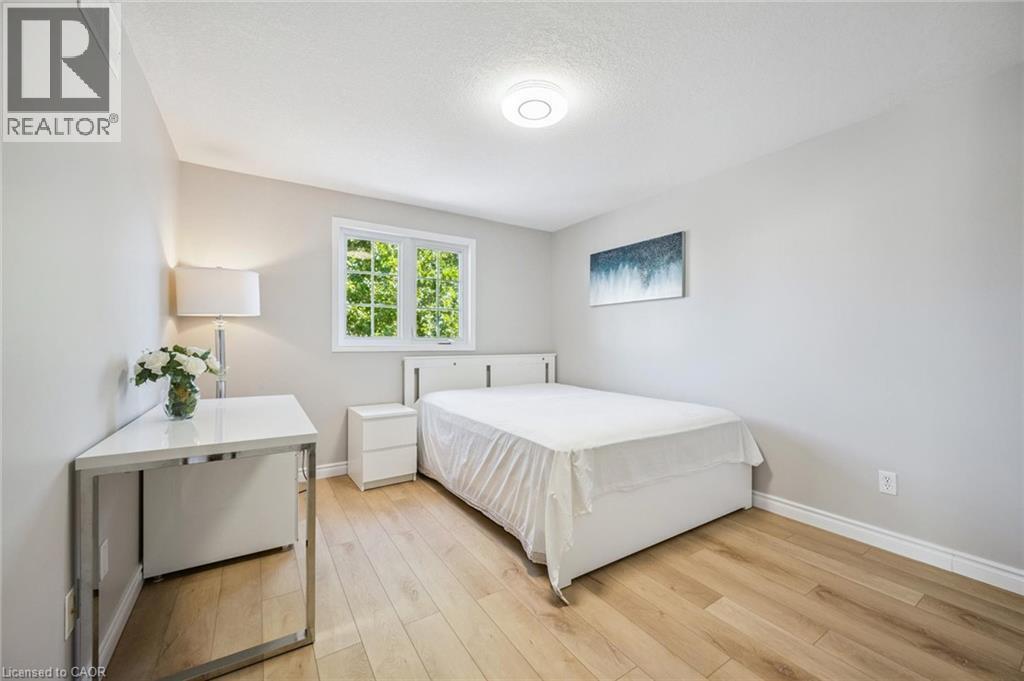 Bedroom featuring light wood-style floors and a textured ceiling - 723 Black Cherry Street, Waterloo, ON - Indoor Photo Showing Bedroom