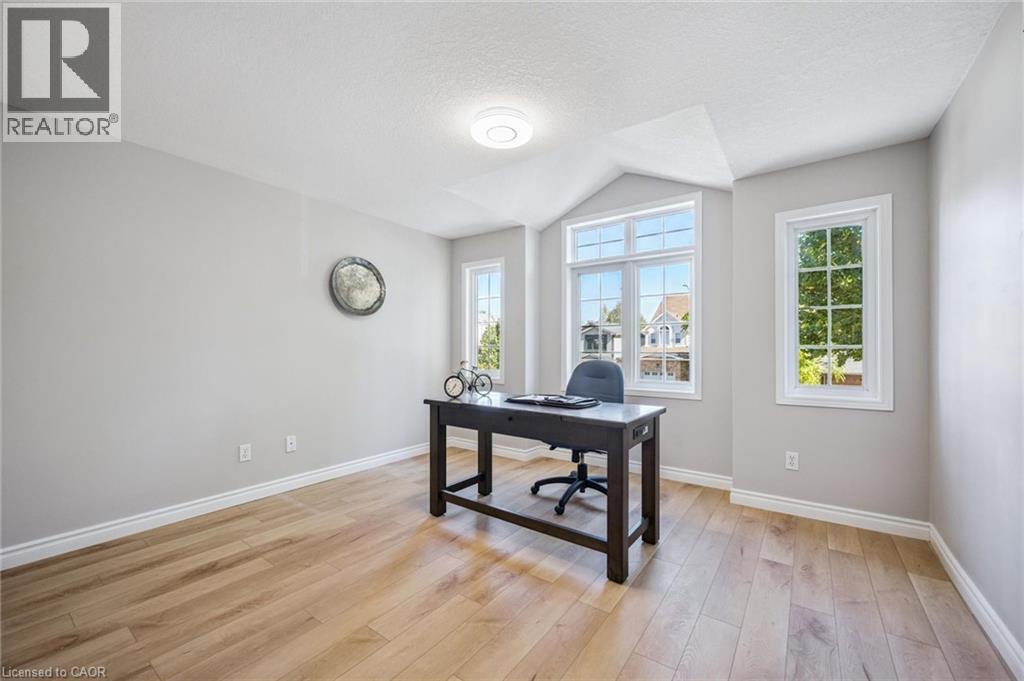 Office space with plenty of natural light, light wood-style flooring, and a textured ceiling - 723 Black Cherry Street, Waterloo, ON - Indoor Photo Showing Office