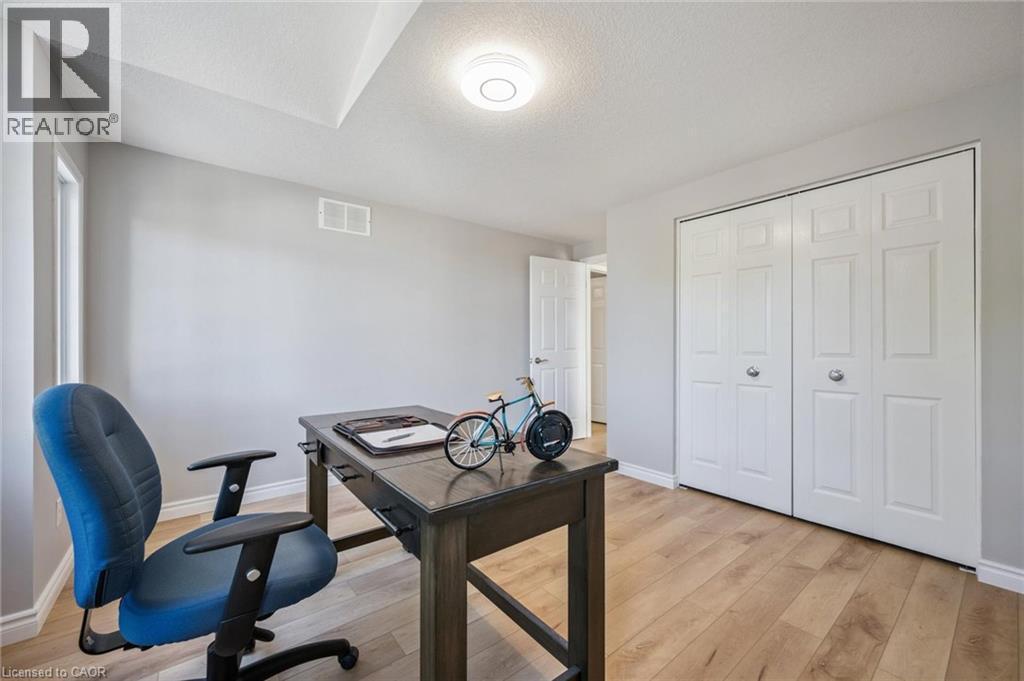 Office space with a textured ceiling and light wood finished floors - 723 Black Cherry Street, Waterloo, ON - Indoor Photo Showing Other Room