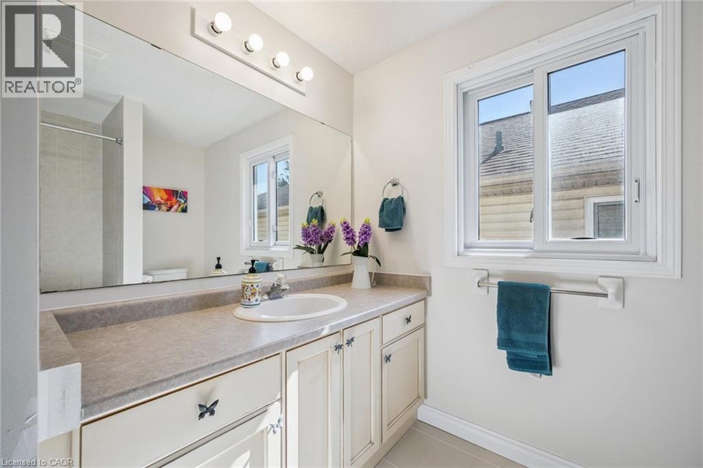 Bathroom featuring vanity, light tile patterned floors, and a shower - 723 Black Cherry Street, Waterloo, ON - Indoor Photo Showing Bathroom