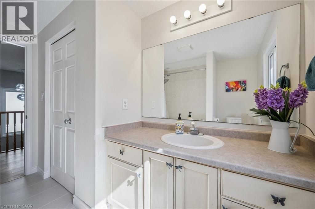 Bathroom with vanity, light tile patterned flooring, and a shower - 723 Black Cherry Street, Waterloo, ON - Indoor Photo Showing Bathroom