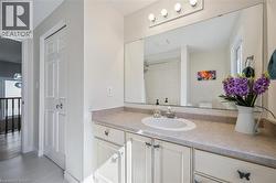 Bathroom with vanity, light tile patterned flooring, and a shower -