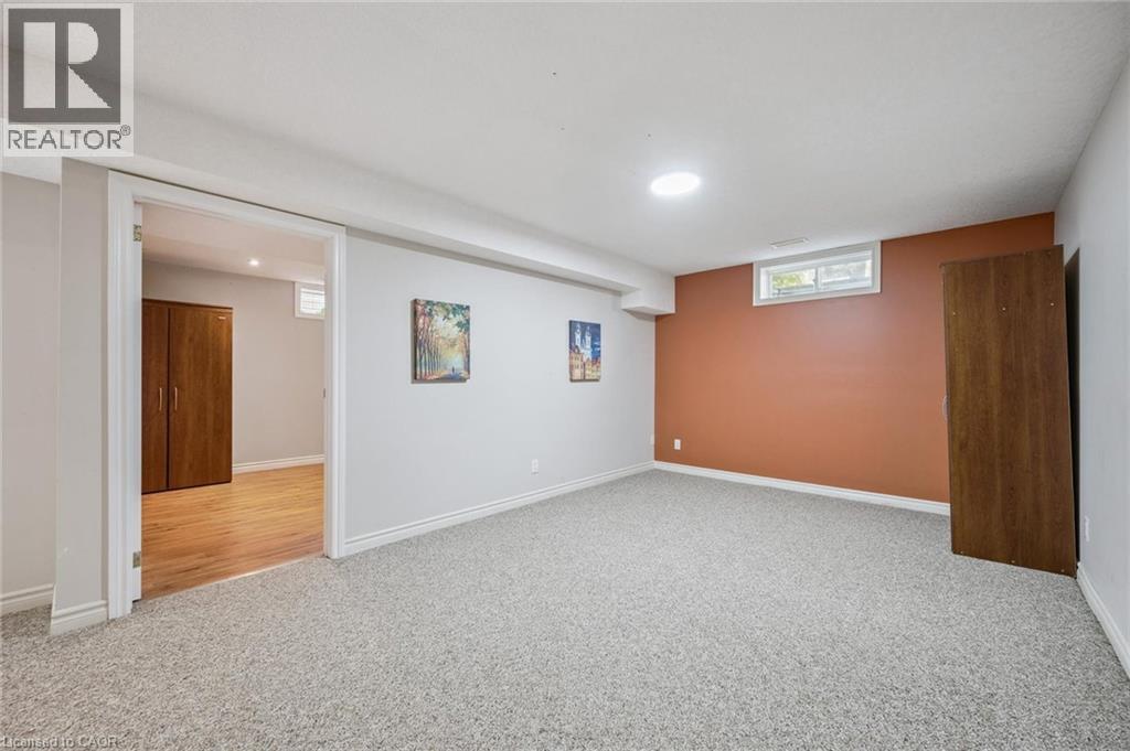 Basement featuring carpet and baseboards - 723 Black Cherry Street, Waterloo, ON - Indoor Photo Showing Basement