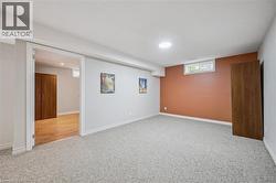 Basement featuring carpet and baseboards -