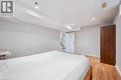 Bedroom with light wood-type flooring and recessed lighting -