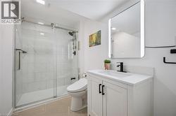 Full bath with a marble finish shower, vanity, and light tile patterned floors -