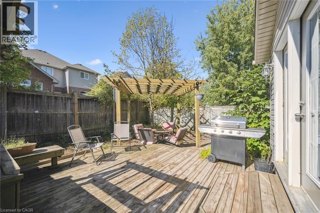 Wooden terrace with a fenced backyard, grilling area, and a pergola - 723 Black Cherry Street, Waterloo, ON - Outdoor With Deck Patio Veranda
