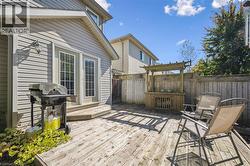 Wooden deck featuring area for grilling -
