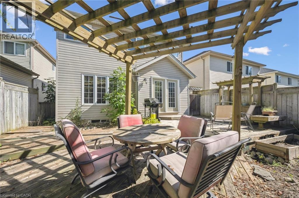 Fenced backyard with a pergola, outdoor dining space, a patio, and area for grilling - 723 Black Cherry Street, Waterloo, ON - Outdoor With Deck Patio Veranda