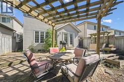 Fenced backyard with a pergola, outdoor dining space, a patio, and area for grilling -