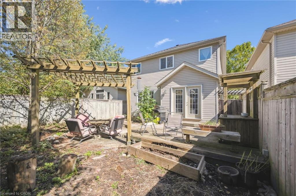 Rear view of property with a fenced backyard, a wooden deck, french doors, and a pergola - 723 Black Cherry Street, Waterloo, ON - Outdoor With Deck Patio Veranda