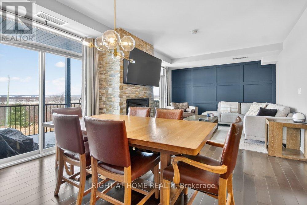 Breathtaking view of the Ottawa River. - 6 - 30 Prestige Circle, Ottawa, ON - Indoor Photo Showing Dining Room With Fireplace