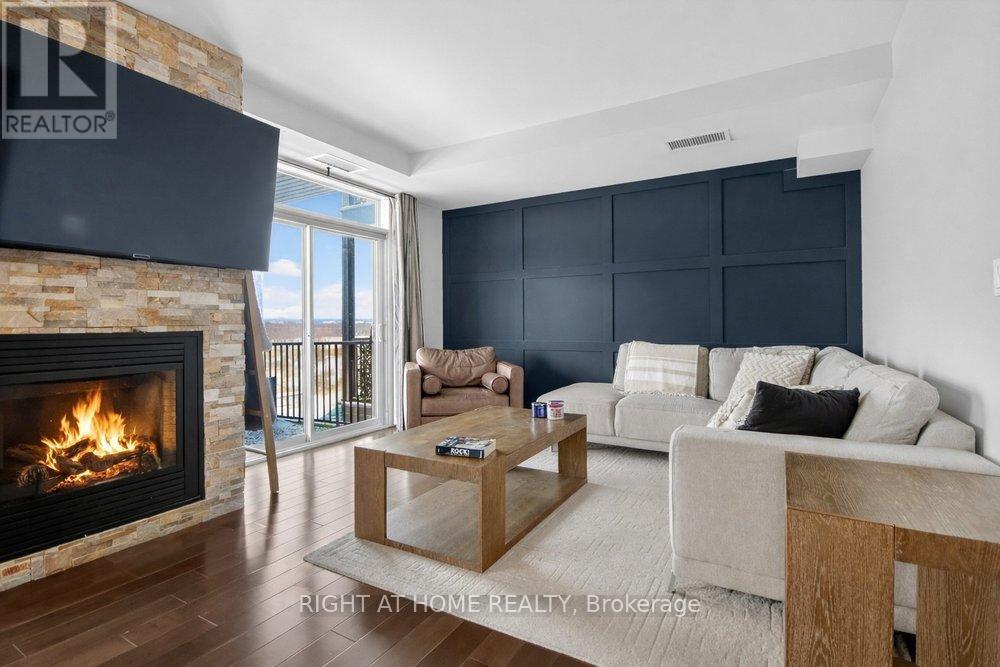 Updated hardwood flooring throughout. - 6 - 30 Prestige Circle, Ottawa, ON - Indoor Photo Showing Living Room With Fireplace