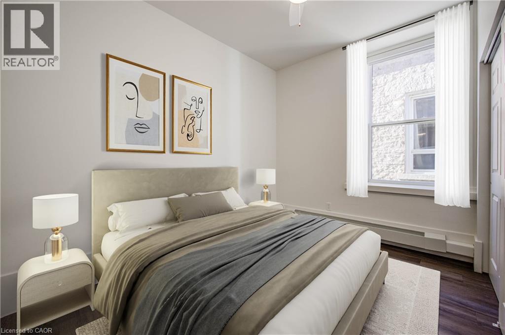 Luxury vinyl plank flooring and generous sized closet. Window overlooking The Galtway. Virtually staged. - 28 Main Street Unit# 8, Cambridge, ON - Indoor Photo Showing Bedroom