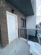 View of exterior entry featuring brick siding -