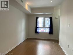 Spare room with wood finished floors and baseboards -