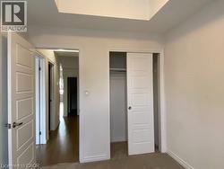 Unfurnished bedroom with a closet and dark colored carpet -