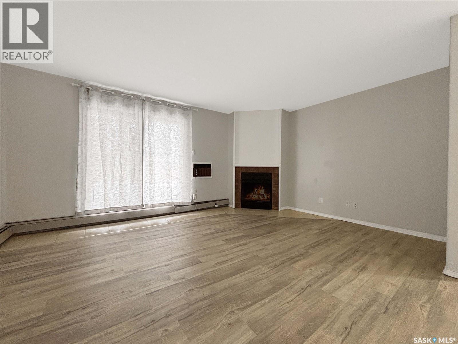 B03 245 Kingsmere Boulevard, Saskatoon, SK - Indoor Photo Showing Other Room With Fireplace